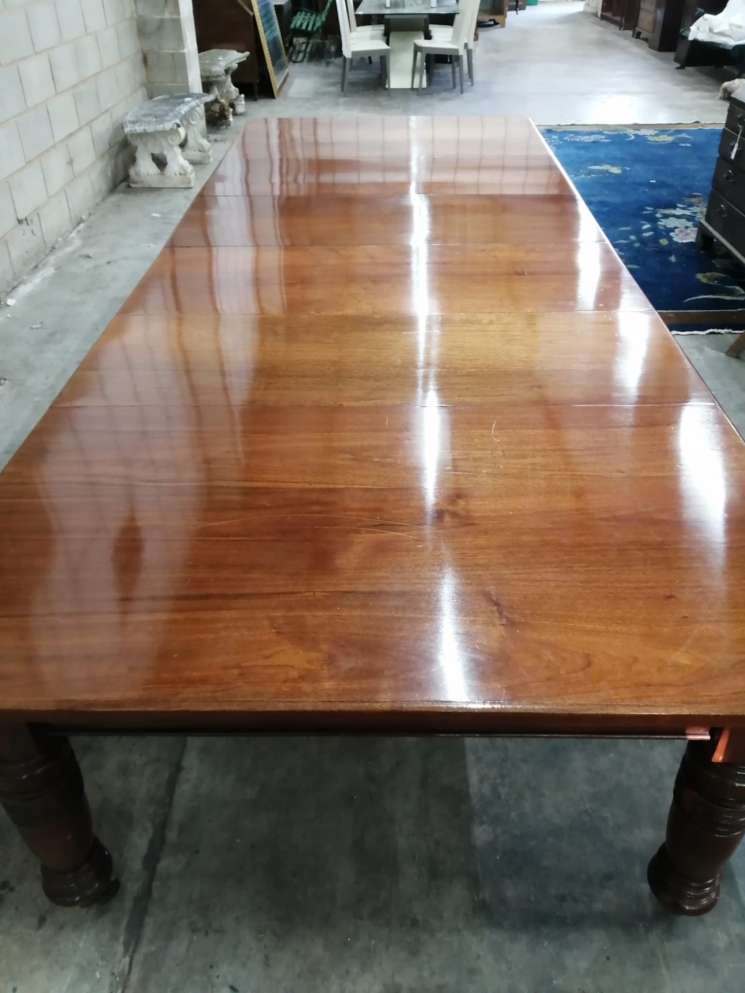 A large Edwardian walnut extending dining table with four leaves, extends to 358 x 138cm, height 74cm